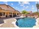 Stunning backyard featuring a sparkling pool, rock waterfall, and covered outdoor seating at 16648 W Adams St, Goodyear, AZ 85338