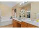 Bright bathroom features dual sinks, vanity and large tub at 16648 W Adams St, Goodyear, AZ 85338
