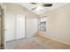 Neutral bedroom featuring a closet, window and neutral colored walls, carpet, and ceiling fan at 16648 W Adams St, Goodyear, AZ 85338