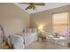 Cozy bedroom features a twin bed, a white table and chairs, and bright natural lighting at 16648 W Adams St, Goodyear, AZ 85338