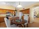 Well-lit kitchen with wooden cabinets, island, and adjacent dining area at 16648 W Adams St, Goodyear, AZ 85338
