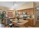 Functional kitchen with stainless steel appliances, island seating, and ample counter space at 16648 W Adams St, Goodyear, AZ 85338