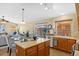 Open-concept kitchen featuring an island, stainless steel dishwasher, and seamless access to the living area at 16648 W Adams St, Goodyear, AZ 85338
