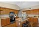 Well-equipped kitchen with a central island, stainless steel appliances, and ample cabinet storage at 16648 W Adams St, Goodyear, AZ 85338