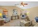 Bright living room with vaulted ceiling, ceiling fan, and comfortable seating arrangement at 16648 W Adams St, Goodyear, AZ 85338