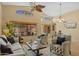 Bright living room featuring high ceilings, large windows, and stylish furnishings with a ceiling fan at 16648 W Adams St, Goodyear, AZ 85338