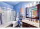 Stylish bathroom showcasing a glass-enclosed shower, vanity with granite countertop, and blue walls at 17017 N 12Th St # 2117, Phoenix, AZ 85022