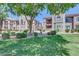 Exterior view showcasing manicured lawn, mature trees, and well-maintained building facades in a residential community at 17017 N 12Th St # 2117, Phoenix, AZ 85022