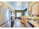 Kitchen features stainless steel appliances and wood cabinets, seamlessly connecting to the dining area at 17017 N 12Th St # 2117, Phoenix, AZ 85022