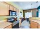 Eat-in kitchen area adjacent to stainless appliances and wood cabinets with views to dining area at 17017 N 12Th St # 2117, Phoenix, AZ 85022