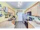 Galley kitchen featuring stainless steel appliances, wood cabinets, and durable laminate countertops at 17017 N 12Th St # 2117, Phoenix, AZ 85022
