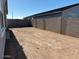 Spacious backyard surrounded by a block wall, providing privacy and room for outdoor activities at 17677 W Odeum Ln, Goodyear, AZ 85338