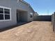 Expansive backyard featuring a covered patio and a privacy wall, perfect for entertaining at 17677 W Odeum Ln, Goodyear, AZ 85338
