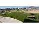 Recreational green space provides fun with built in cornhole game boards for residents at 17677 W Odeum Ln, Goodyear, AZ 85338