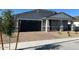Charming single-story home with a brick-paved driveway and a well-manicured front yard at 17677 W Odeum Ln, Goodyear, AZ 85338
