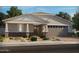 Charming single-story home with brick accents, a two-car garage, and desert landscaping at 17677 W Odeum Ln, Goodyear, AZ 85338