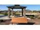 Community gazebo with stone pillars and seating provides a relaxing gathering space at 17677 W Odeum Ln, Goodyear, AZ 85338