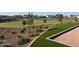 Community green space area with drought resistant shrubs and plants at 17677 W Odeum Ln, Goodyear, AZ 85338