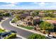 Beautiful aerial view showcasing the home's well-manicured lawn, palm trees, and neighborhood at 18330 W Woodrow Ln, Surprise, AZ 85388
