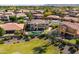 Aerial view of a neighborhood showcasing a home with a large backyard, pool, and well-maintained landscaping at 18330 W Woodrow Ln, Surprise, AZ 85388