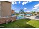 Spacious backyard with a pool, spa, outdoor kitchen, and turf area, ideal for entertaining and outdoor activities at 18330 W Woodrow Ln, Surprise, AZ 85388