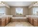 Large soaking tub is the focal point in this spacious bathroom with dual sinks and vanities at 18330 W Woodrow Ln, Surprise, AZ 85388