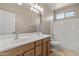 Bright bathroom boasts double sinks, vanity and shower over tub at 18330 W Woodrow Ln, Surprise, AZ 85388