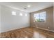 Bedroom featuring wood floors, neutral walls, and a window for natural light at 18330 W Woodrow Ln, Surprise, AZ 85388