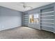 Bedroom featuring neutral paint, carpet, ceiling fan and window at 18330 W Woodrow Ln, Surprise, AZ 85388
