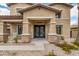 Charming home featuring a covered entrance, stone accents, and an inviting front porch at 18330 W Woodrow Ln, Surprise, AZ 85388