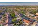 Scenic aerial view of the neighborhood with lush green golf course and mountain backdrop at 19472 N Marble Canyon Ct, Surprise, AZ 85374