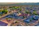 Stunning aerial view of homes in a golf course community with mountain views in the distance at 19472 N Marble Canyon Ct, Surprise, AZ 85374