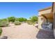 Inviting backyard featuring desert landscaping and a covered patio, perfect for relaxing and entertaining at 19472 N Marble Canyon Ct, Surprise, AZ 85374