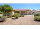 Scenic backyard featuring desert landscaping, mature trees, and a covered patio with seating at 19472 N Marble Canyon Ct, Surprise, AZ 85374
