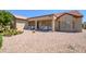 Spacious backyard with desert landscaping and covered patio area with ample seating at 19472 N Marble Canyon Ct, Surprise, AZ 85374