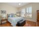 Cozy bedroom with hardwood floors, a ceiling fan, and large windows with plantation shutters at 19472 N Marble Canyon Ct, Surprise, AZ 85374