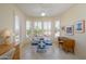 Bright dining area with round table, four chairs, shuttered windows, and tile flooring at 19472 N Marble Canyon Ct, Surprise, AZ 85374