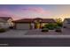 Inviting single-story home with desert landscaping, a tile roof, and a two-car garage at 19472 N Marble Canyon Ct, Surprise, AZ 85374