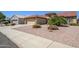 Attractive single-story home featuring desert landscaping, a two-car garage and a terracotta tile roof at 19472 N Marble Canyon Ct, Surprise, AZ 85374