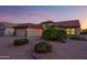 Well-kept single-story home featuring desert landscaping, a tile roof, and a two-car garage at 19472 N Marble Canyon Ct, Surprise, AZ 85374