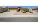 Charming single-story home featuring a well-maintained yard, a two-car garage, and a beautiful red tile roof at 19472 N Marble Canyon Ct, Surprise, AZ 85374