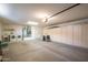 Spacious garage with laundry facilities, shelving, and a garage door opener at 19472 N Marble Canyon Ct, Surprise, AZ 85374