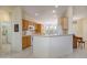 Bright open kitchen featuring tile floors, wooden cabinets, white appliances, and lots of counter space at 19472 N Marble Canyon Ct, Surprise, AZ 85374