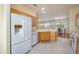 Bright kitchen featuring wooden cabinets, tile flooring, and a full-size refrigerator at 19472 N Marble Canyon Ct, Surprise, AZ 85374