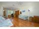 Expansive room with wood floors, ceiling fan, built-in bookshelves and natural light at 19472 N Marble Canyon Ct, Surprise, AZ 85374
