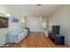 Spacious living room with wood floors, two sofas, ceiling fan and natural light at 19472 N Marble Canyon Ct, Surprise, AZ 85374