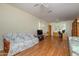 Large room with wood floors, ceiling fans, built-in bookshelves and natural light at 19472 N Marble Canyon Ct, Surprise, AZ 85374