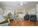 Open living area with hardwood floors, comfortable seating, and a seamless connection to the kitchen and dining area at 19472 N Marble Canyon Ct, Surprise, AZ 85374