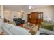 Well-lit living space featuring hardwood floors, comfortable seating, built in shelving, and an open layout at 19472 N Marble Canyon Ct, Surprise, AZ 85374