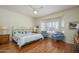 Comfortable main bedroom with hardwood floors, seating area, and large windows with plantation shutters at 19472 N Marble Canyon Ct, Surprise, AZ 85374